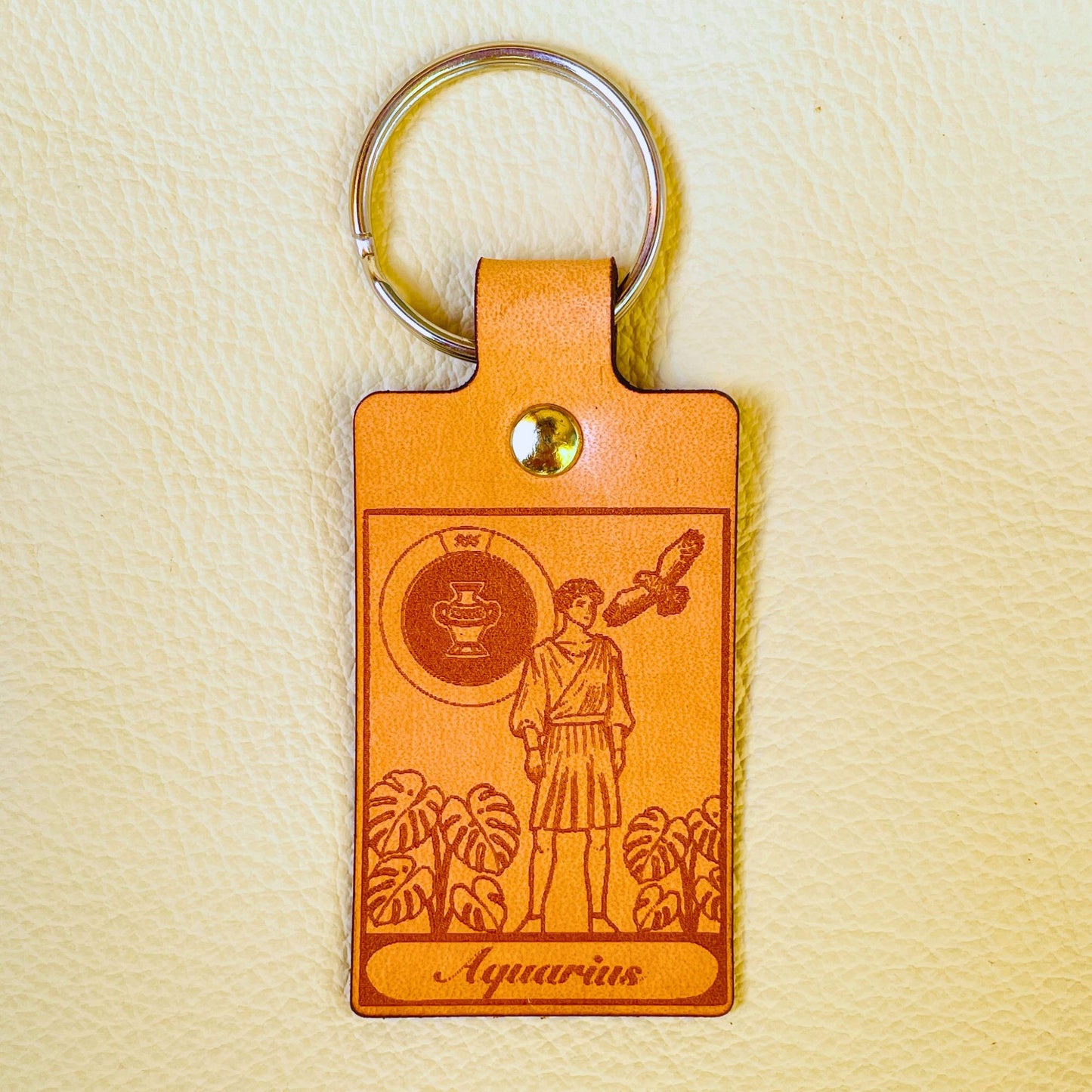 SteamVoyage - mini portachiavi in cuoio con immagini ispirate ai segni zodiacali e ai miti greci e romani che li raccontano - aquarius