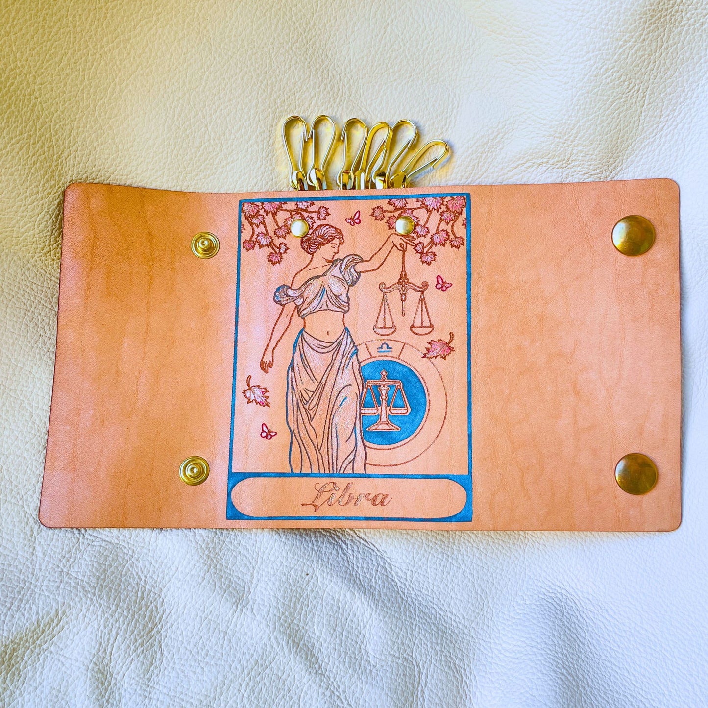 SteamVoyage - portachiavi in cuoio inciso al laser e dipinto a mano con immagini ispirate ai segni zodiacali e ai relativi miti greci e romani - bilancia azzurro aperto